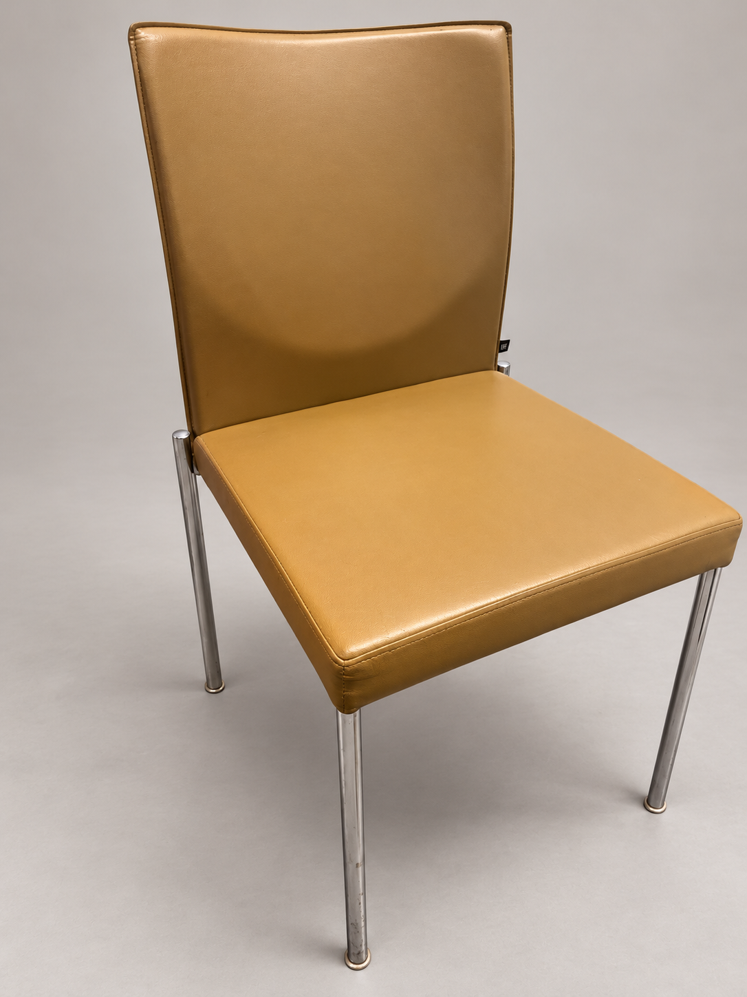KFF chair angle view; edited studio background; originals retained