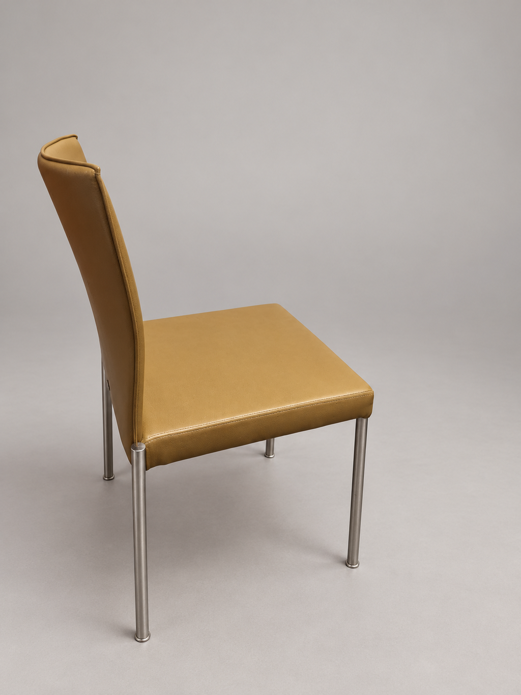 KFF chair angle view; edited studio background; originals retained