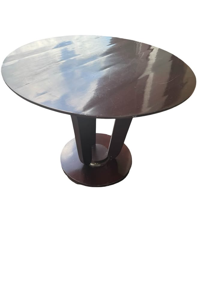 Baker round wood table full view showing pedestal base and visible surface wear