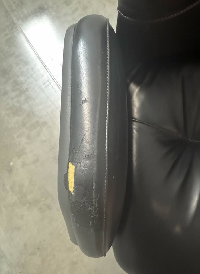 Unchanged close-up of cracked and peeling arm upholstery with exposed foam