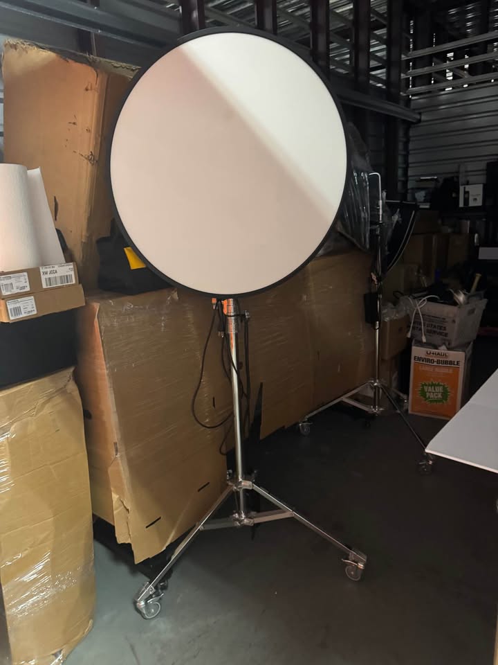 Actual FlapJack Studio XL LED edge light front view on chrome rolling stand in storage