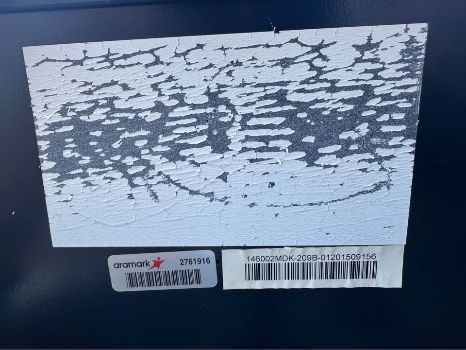 Asset labels and visible surface wear on the actual Kegco cabinet
