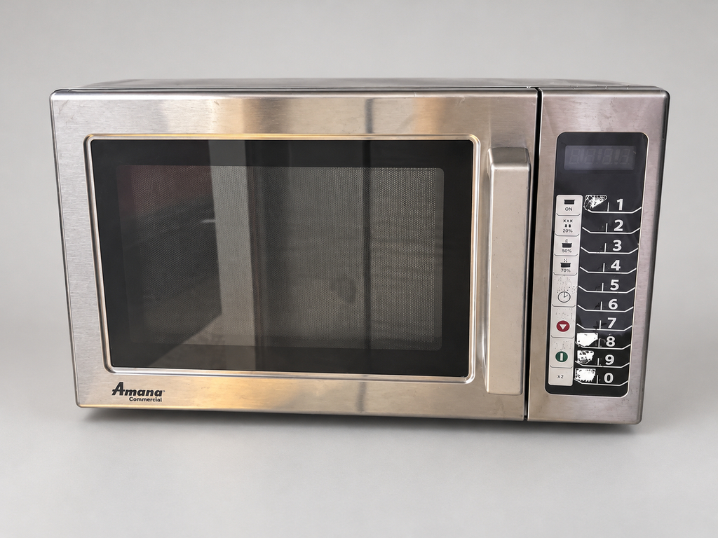 Actual Amana microwave front view with digitally staged background; worn controls retained