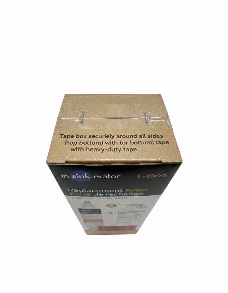 Original top view showing tape and staples on the exact InSinkErator F-1000 package.