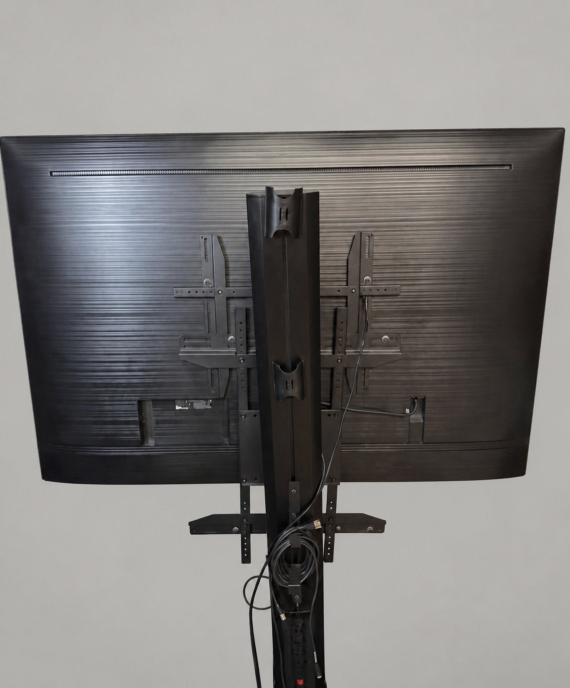 Samsung TV rear mounting hardware and cables; background edited and original cropped stand view retained.