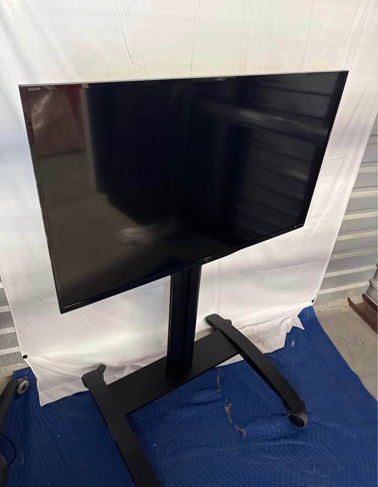 Sharp LC-50LE650U display and cart — genuine front and screen-condition view