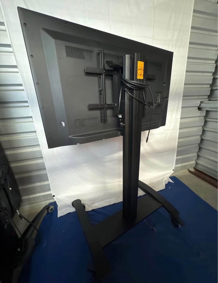 Sharp LC-50LE650U display — rear panel, installed mount and rolling cart