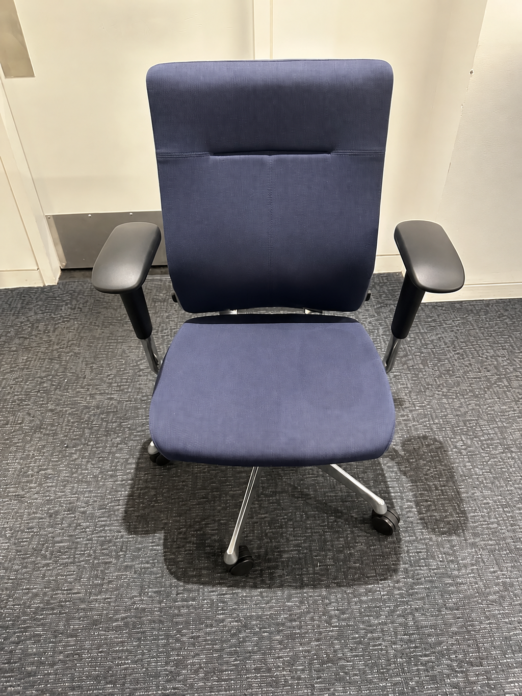 Blue upholstered rolling office chair front view; unrelated second-chair edge removed; actual chair unchanged; original retained privately