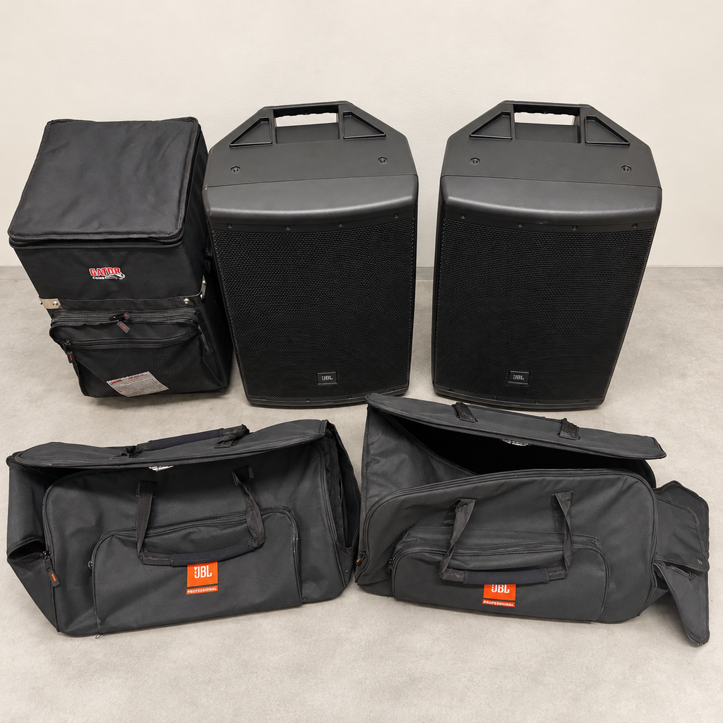 Two actual JBL EON615 speakers with photographed cases on a clean staged neutral background; package or separate by agreement.