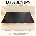 LG 32BL75U-W actual monitor hero with staged cream background; power cord and adapter included, no stand.