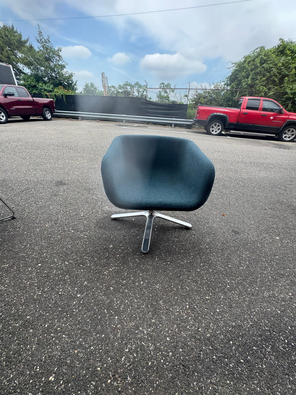 Original front view of a blue Hightower lounge chair with a curved seat and metal pedestal base, June 26, 2026.