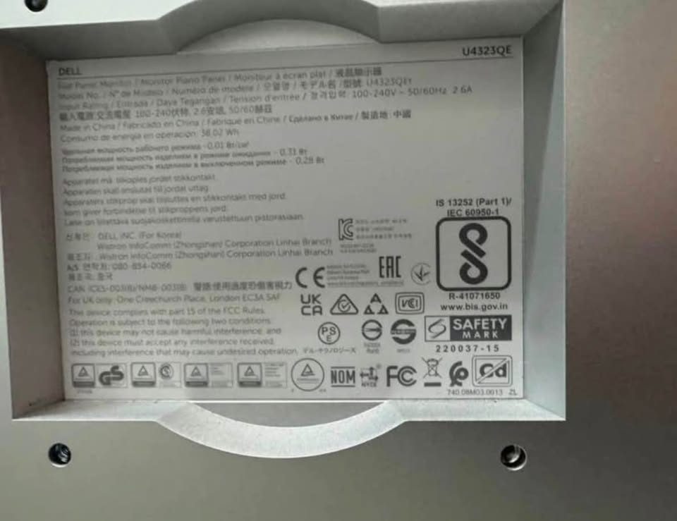 Untouched close-up of the Dell regulatory label identifying model U4323QE.
